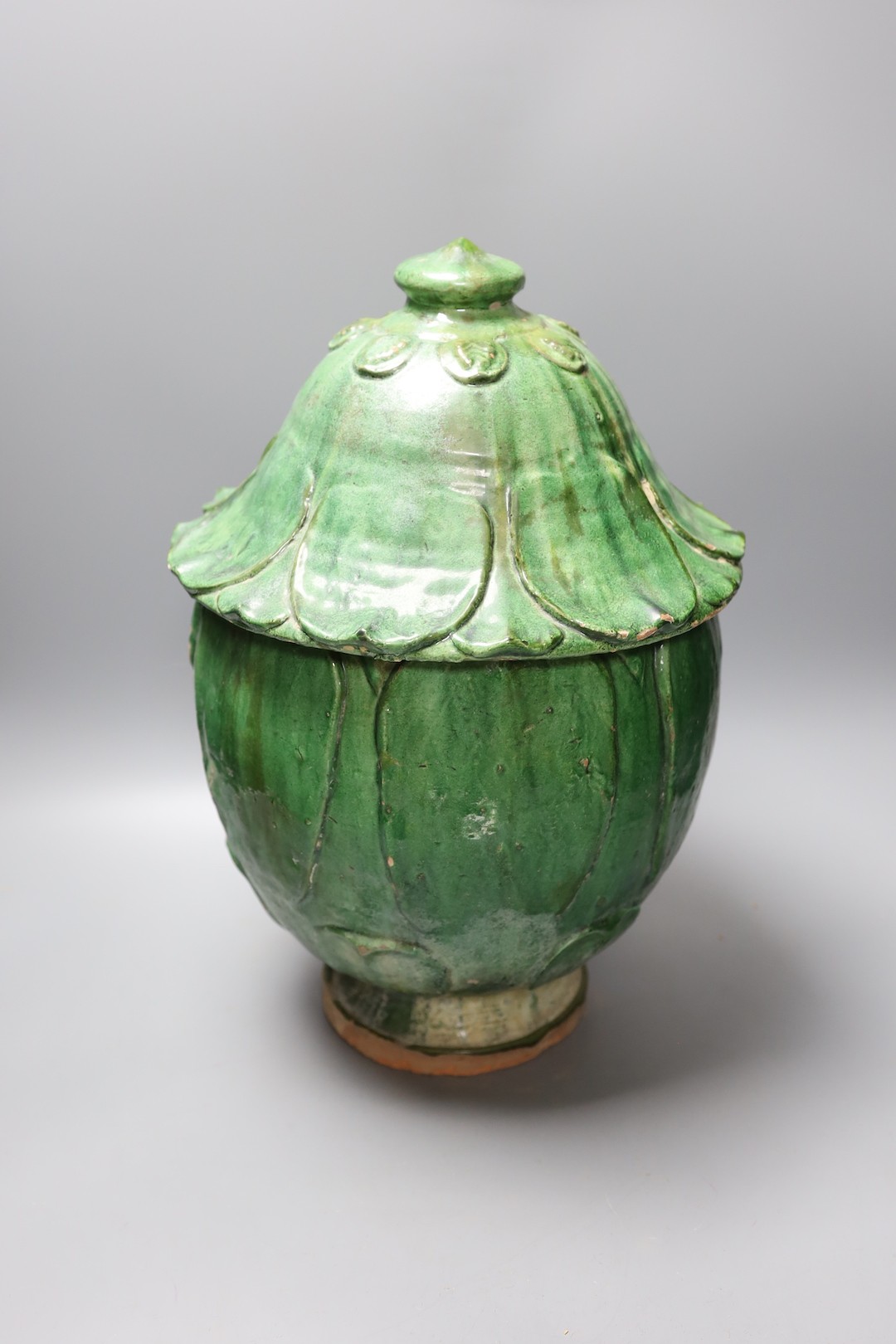 A Buddhist green glazed pottery jar and cover, 10th - 13th century. Thermoluminescence analysis report included, 43cm